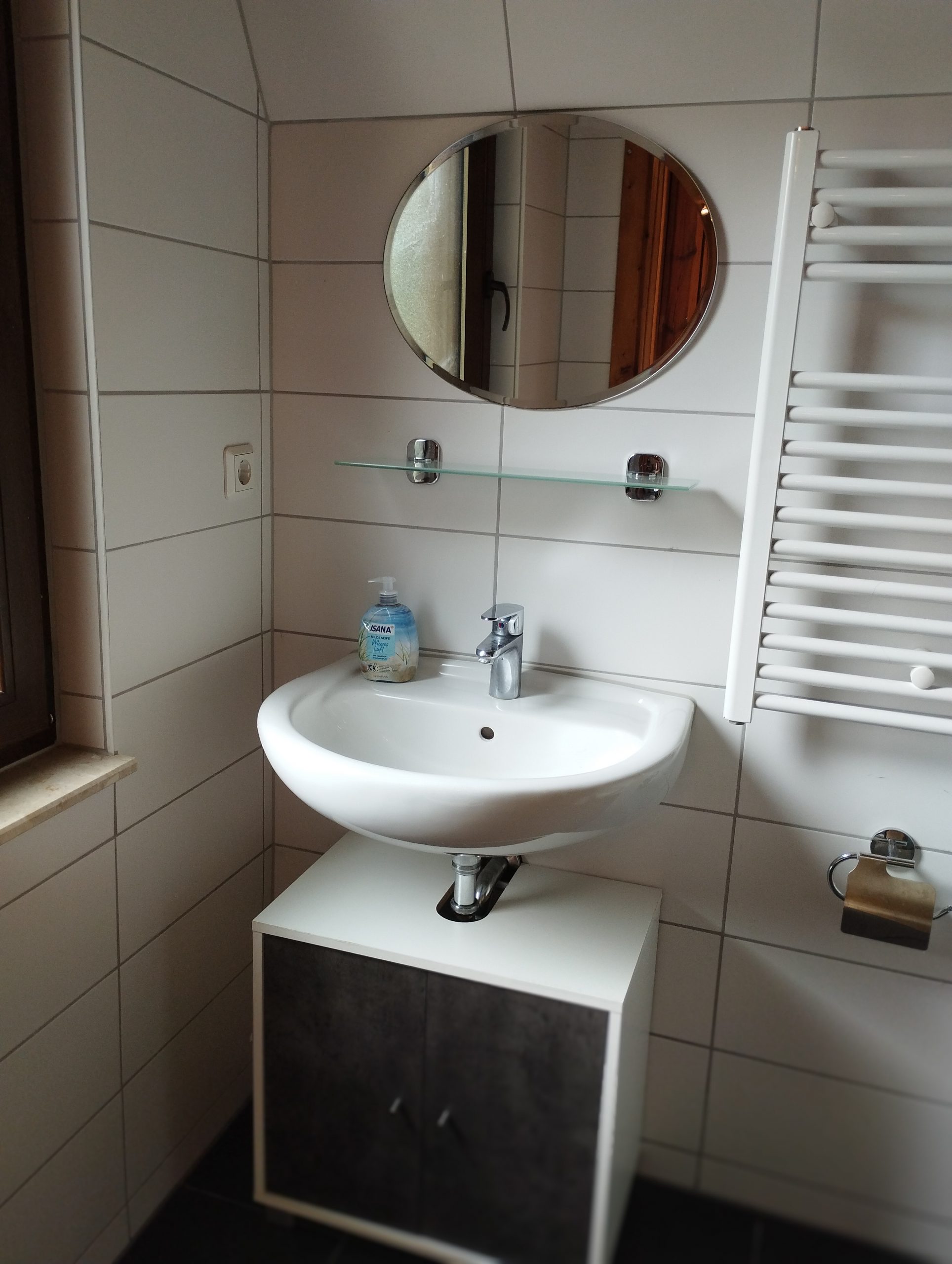 Waschbecken mit Spiegel und Handtuchhalter